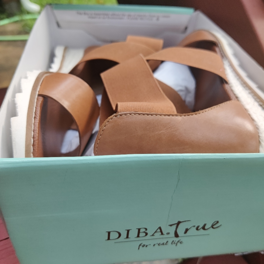 Leather and elastic straps wrap a casual sandal wi